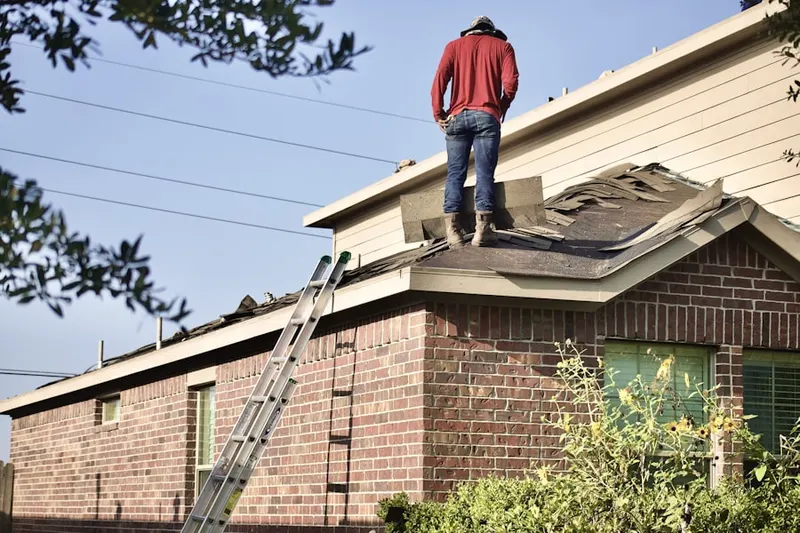 Professional roofer working on a residential roof in Hawfields